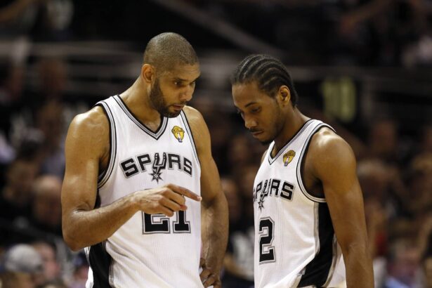 Jun 11, 2013; San Antonio, TX, USA; San Antonio Spurs power forward Tim Duncan (21) talks with small forward Kawhi Leonard (2) during the first quarter of game three of the 2013 NBA Finals against the Miami Heat at the AT&T Center. Mandatory Credit: Soobum Im-Imagn Images