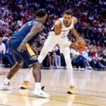 Spurs forward/center Victor Wembanyama dribbles against Pelicans forward Zion Williamson during the first half at Smoothie King Center