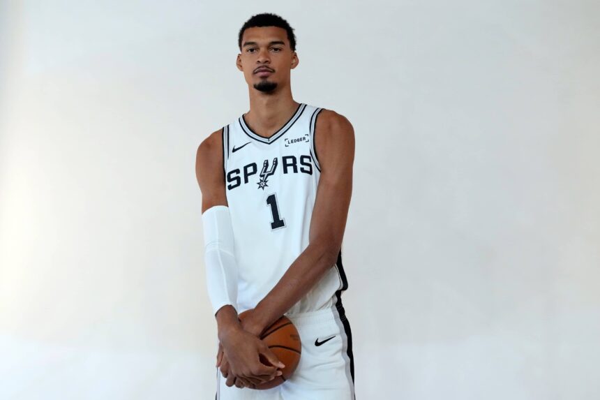 Spurs forward-center Victor Wembanyama poses for photos during Media Day at Victory Capital Performance Center in San Antonio