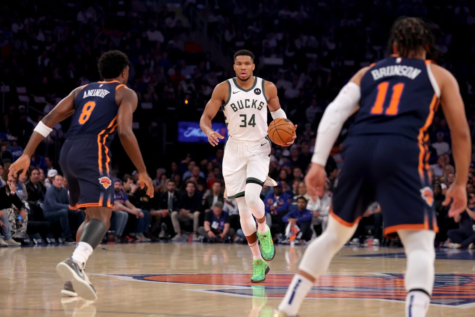 Nov 8, 2024; New York, New York, USA; Milwaukee Bucks forward Giannis Antetokounmpo (34) brings the ball up court against New York Knicks forward OG Anunoby (😎 and guard Jalen Brunson (11) during the first quarter at Madison Square Garden. Mandatory Credit: Brad Penner-Imagn Images