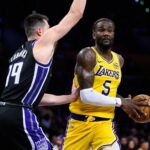 Los Angeles, California, USA; Los Angeles Lakers center Deandre Ayton (5) drives the ball against Sacramento Kings forward/center Drew Eubanks (19) during the second half at Crypto.com Arena. Mandatory Credit: William Liang-Imagn Images