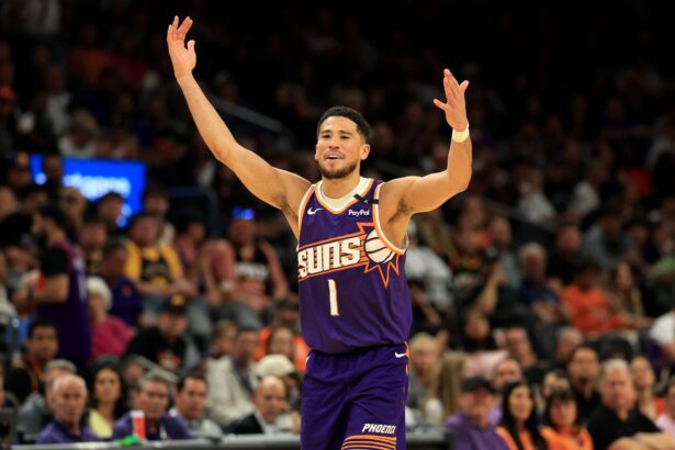 Phoenix, Arizona, USA; Phoenix Suns guard Devin Booker (1) reacts against the Golden State Warriors at Footprint Center. Mandatory Credit: Mark J. Rebilas-Imagn Images
