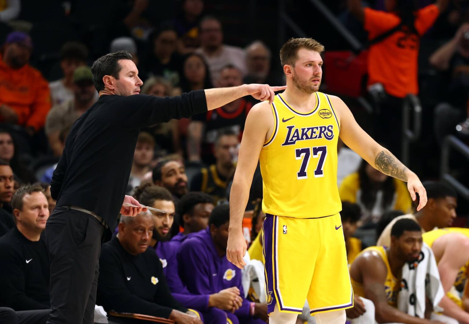 Phoenix, Arizona, USA; Los Angeles Lakers guard Luka Doncic (77) with head coach JJ Redick against the Phoenix Suns during an NBA preseason game at Mortgage Matchup Center. Mandatory Credit: Mark J. Rebilas-Imagn Images