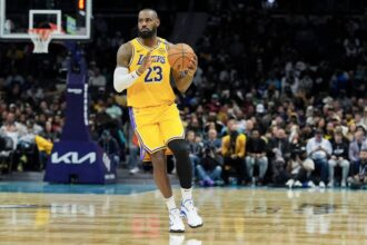 Charlotte, North Carolina, USA; Los Angeles Lakers forward LeBron James (23) brings the ball up court against the Charlotte Hornets during the first quarter at the Spectrum Center. Mandatory Credit: Jim Dedmon-Imagn Images