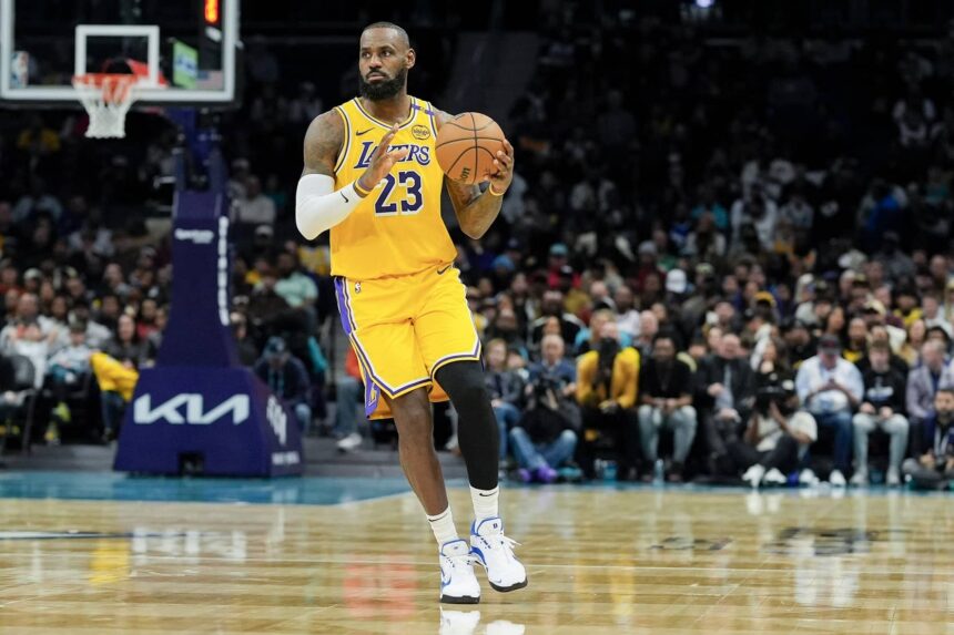Charlotte, North Carolina, USA; Los Angeles Lakers forward LeBron James (23) brings the ball up court against the Charlotte Hornets during the first quarter at the Spectrum Center. Mandatory Credit: Jim Dedmon-Imagn Images
