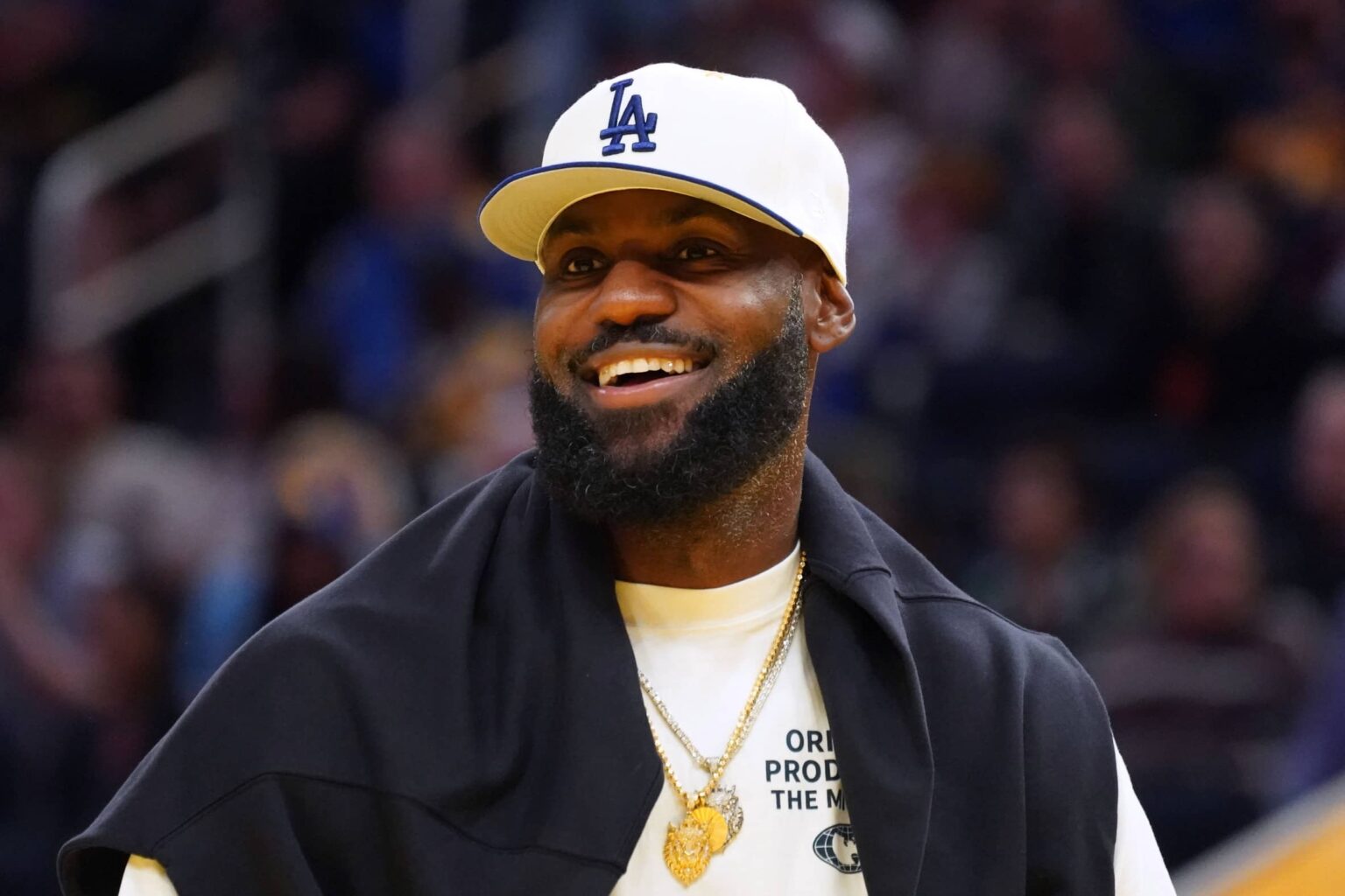 San Francisco, California, USA; Los Angeles Lakers forward LeBron James (23), wearing a Los Angeles Dodgers hat, watches from the sideline during a break against the Golden State Warriors in the third quarter at Chase Center. Mandatory Credit: David Gonzales-Imagn Images