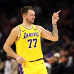 Phoenix, Arizona, USA; Los Angeles Lakers guard Luka Doncic (77) reacts against the Phoenix Suns during an NBA preseason game at Mortgage Matchup Center. Mandatory Credit: Mark J. Rebilas-Imagn Images
