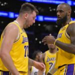 Los Angeles, California, USA; Los Angeles Lakers forward LeBron James (23) checks on guard Luka Doncic (77) after he was hit in the face against the Utah Jazz at Crypto.com Arena. Mandatory Credit: Jayne Kamin-Oncea-Imagn Images