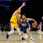 Los Angeles, California, USA; Golden State Warriors guard Stephen Curry (30) drives against Los Angeles Lakers guard Luka Doncic (77) during the second half at Crypto.com Arena. Mandatory Credit: William Liang-Imagn Images