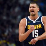 Denver, Colorado, USA; Denver Nuggets center Nikola Jokic (15) talks with the bench during the first half against the Phoenix Suns at Ball Arena. Mandatory Credit: Christopher Hanewinckel-Imagn Images