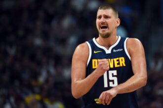 Denver, Colorado, USA; Denver Nuggets center Nikola Jokic (15) talks with the bench during the first half against the Phoenix Suns at Ball Arena. Mandatory Credit: Christopher Hanewinckel-Imagn Images