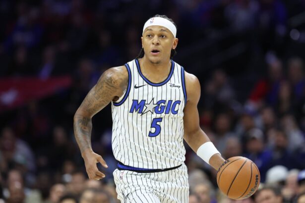Philadelphia, Pennsylvania, USA; Orlando Magic forward Paolo Banchero (5) dribbles the ball against the Philadelphia 76ers during the first quarter at Xfinity Mobile Arena. Mandatory Credit: Bill Streicher-Imagn Images