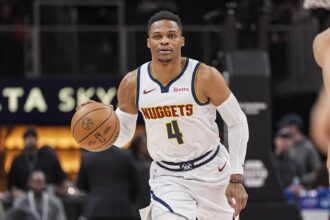 Atlanta, Georgia, USA; Denver Nuggets guard Russell Westbrook (4) brings the ball up the court against the Atlanta Hawks during the first half at State Farm Arena. Mandatory Credit: Dale Zanine-Imagn Images
