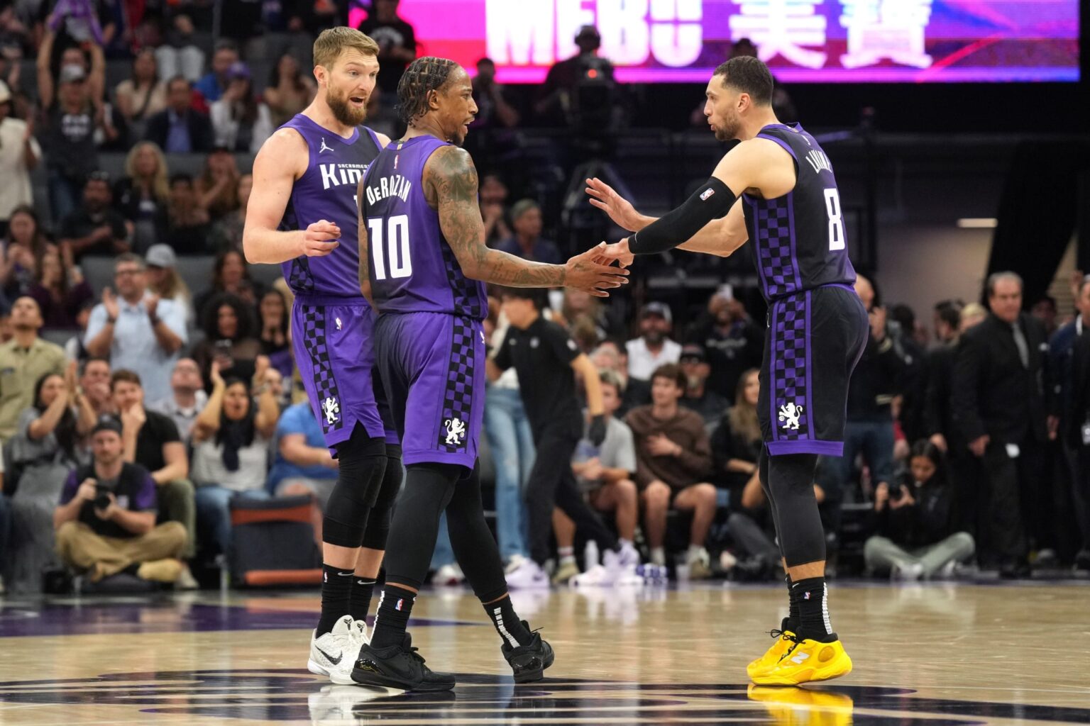 Apr 11, 2025; Sacramento, California, USA; Sacramento Kings forward DeMar DeRozan (10) talks with forward Domantas Sabonis (left) and guard Zach LaVine (😎 during the fourth quarter against the Los Angeles Clippers at Golden 1 Center. Mandatory Credit: Darren Yamashita-Imagn Images