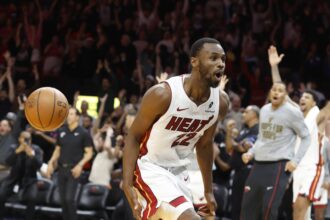 Miami Heat forward Andrew Wiggins (22) reacts after he dunks to win the game against the Cleveland Cavaliers during overtime at Kaseya Center.