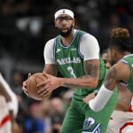 Dallas Mavericks forward Anthony Davis (3) looks to hand the ball off to guard D'Angelo Russell (5) during the second quarter against the Toronto Raptors at the American Airlines Center.