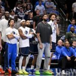 Nov 14, 2025; Dallas, Texas, USA; Dallas Mavericks forward Anthony Davis (black shirt) watches from the team bench with his teammates during the second half against the LA Clippers in an NBA Cup game at the American Airlines Center. Mandatory Credit: Jerome Miron-Imagn Images