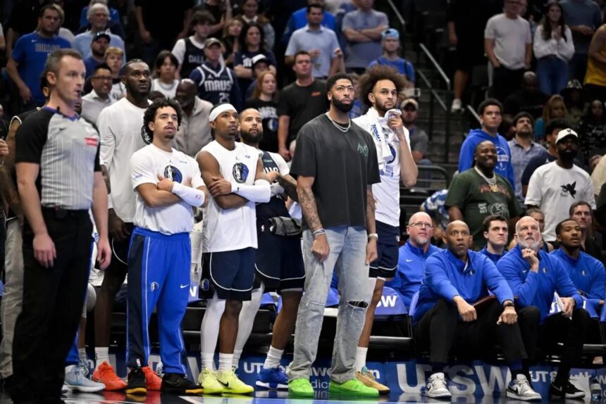 Nov 14, 2025; Dallas, Texas, USA; Dallas Mavericks forward Anthony Davis (black shirt) watches from the team bench with his teammates during the second half against the LA Clippers in an NBA Cup game at the American Airlines Center. Mandatory Credit: Jerome Miron-Imagn Images