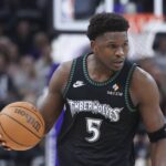 Minnesota Timberwolves guard Anthony Edwards (5) brings the ball up the court against the Utah Jazz during the second half at Delta Center.