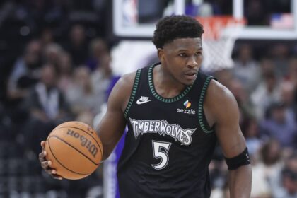 Minnesota Timberwolves guard Anthony Edwards (5) brings the ball up the court against the Utah Jazz during the second half at Delta Center.