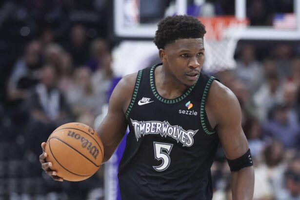 Minnesota Timberwolves guard Anthony Edwards (5) brings the ball up the court against the Utah Jazz during the second half at Delta Center.