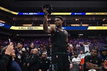 Nov 9, 2025; Sacramento, California, USA; Minnesota Timberwolves guard Anthony Edwards (5) gives his jersey to a young fan during the fourth quarter against the Sacramento Kings at Golden 1 Center. Mandatory Credit: Justine Willard-Imagn Images