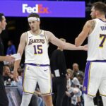 Los Angeles Lakers head coach JJ Redick talks with guard Austin Reaves (15) and guard Luka Doncic (77) during the fourth quarter against the Memphis Grizzlies at FedExForum.