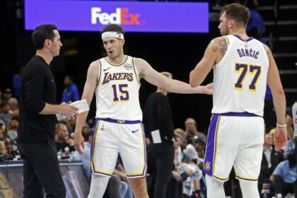 Los Angeles Lakers head coach JJ Redick talks with guard Austin Reaves (15) and guard Luka Doncic (77) during the fourth quarter against the Memphis Grizzlies at FedExForum.