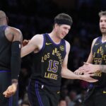 Nov 18, 2025; Los Angeles, California, USA; Los Angeles Lakers guard Austin Reaves (15) is congratulated by forward LeBron James (23) and guard Luka Doncic (77) after a three-point basket in the second quarter at Crypto.com Arena. Mandatory Credit: Kirby Lee-Imagn Images