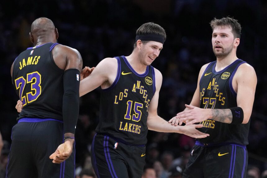 Nov 18, 2025; Los Angeles, California, USA; Los Angeles Lakers guard Austin Reaves (15) is congratulated by forward LeBron James (23) and guard Luka Doncic (77) after a three-point basket in the second quarter at Crypto.com Arena. Mandatory Credit: Kirby Lee-Imagn Images