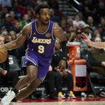 Los Angeles Lakers guard Bronny James (9) drives to the basket during the second half against Portland Trail Blazers forward Deni Avdija (8) at Moda Center.