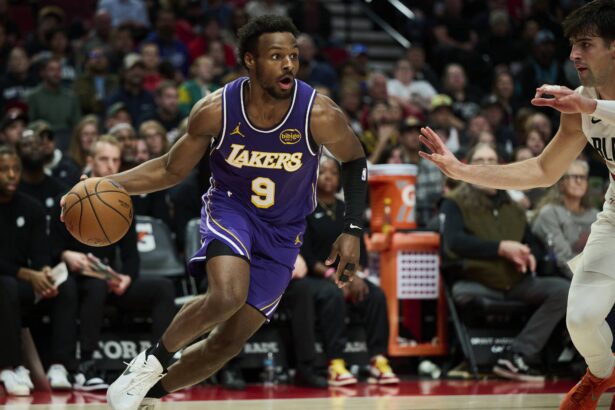 Los Angeles Lakers guard Bronny James (9) drives to the basket during the second half against Portland Trail Blazers forward Deni Avdija (8) at Moda Center.
