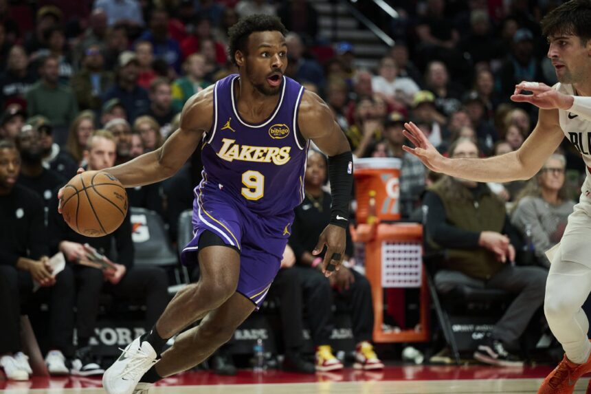 Los Angeles Lakers guard Bronny James (9) drives to the basket during the second half against Portland Trail Blazers forward Deni Avdija (8) at Moda Center.