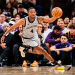 San Antonio Spurs guard De'Aaron Fox (4) regains control of the ball in the second half of the game at Mortgage Match Up Center.