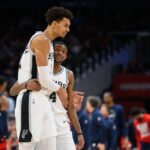 San Antonio Spurs center Victor Wembanyama (1) and guard De'Aaron Fox (4) react during the second quarter against the Washington Wizards at Capital One Arena.
