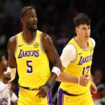 Oct 14, 2025; Phoenix, Arizona, USA; Los Angeles Lakers center Deandre Ayton (5) and forward Jake LaRavia (12) against the Phoenix Suns during an NBA preseason game at Mortgage Matchup Center. Mandatory Credit: Mark J. Rebilas-Imagn Images