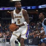 Oct 31, 2025; Memphis, Tennessee, USA; Los Angeles Lakers center Deandre Ayton (5) spins to the basket as Memphis Grizzlies forward Vince Williams Jr. (5) defends during the second quarter at FedExForum. Mandatory Credit: Petre Thomas-Imagn Images