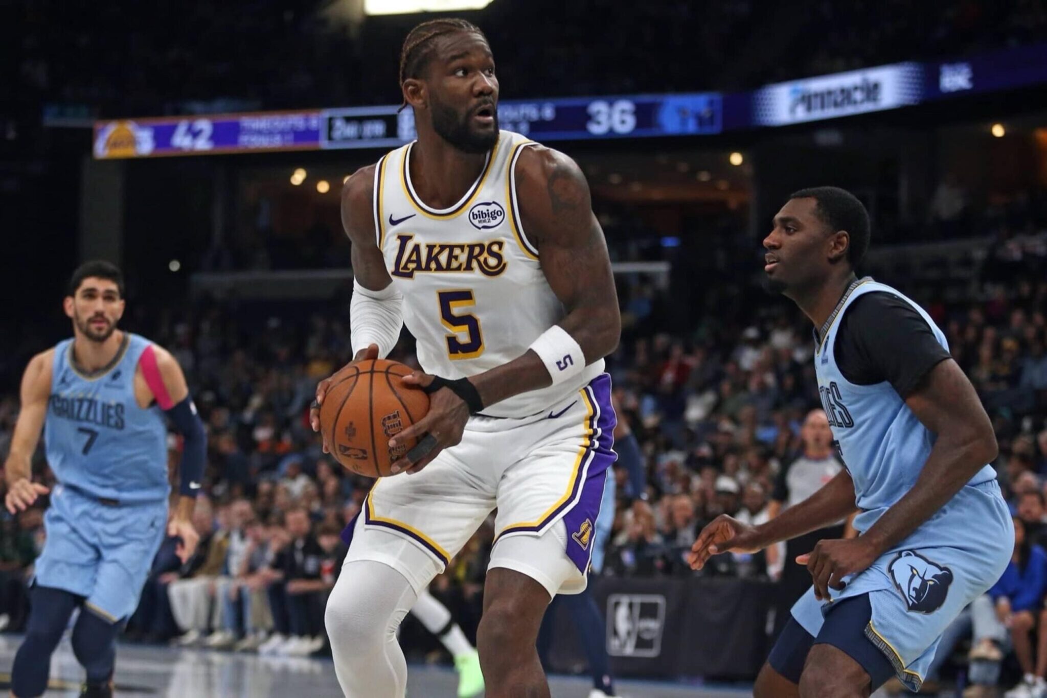 Oct 31, 2025; Memphis, Tennessee, USA; Los Angeles Lakers center Deandre Ayton (5) spins to the basket as Memphis Grizzlies forward Vince Williams Jr. (5) defends during the second quarter at FedExForum. Mandatory Credit: Petre Thomas-Imagn Images