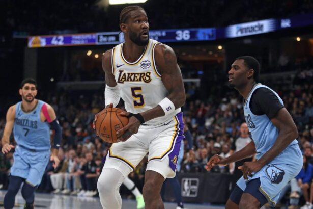 Oct 31, 2025; Memphis, Tennessee, USA; Los Angeles Lakers center Deandre Ayton (5) spins to the basket as Memphis Grizzlies forward Vince Williams Jr. (5) defends during the second quarter at FedExForum. Mandatory Credit: Petre Thomas-Imagn Images