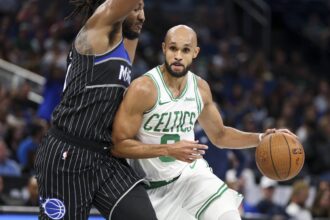 Boston Celtics guard Derrick White (9) drives to the basket past Orlando Magic center Wendell Carter Jr. (34) in the second quarter at Kia Center.