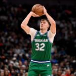 Oct 26, 2025; Dallas, Texas, USA; Dallas Mavericks forward Cooper Flagg (32) makes a three point shot against the Toronto Raptors during the second half at the American Airlines Center. Mandatory Credit: Jerome Miron-Imagn Images