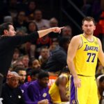 Oct 14, 2025; Phoenix, Arizona, USA; Los Angeles Lakers guard Luka Doncic (77) with head coach JJ Redick against the Phoenix Suns during an NBA preseason game at Mortgage Matchup Center. Mandatory Credit: Mark J. Rebilas-Imagn Images