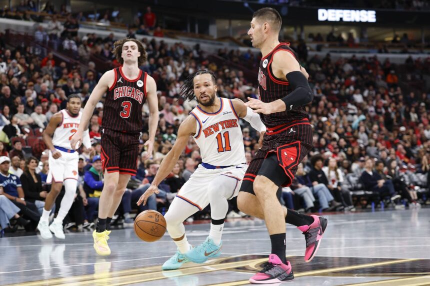 Chicago Bulls center Nikola Vucevic (9) defends against New York Knicks guard Jalen Brunson (11) during the second half at United Center.