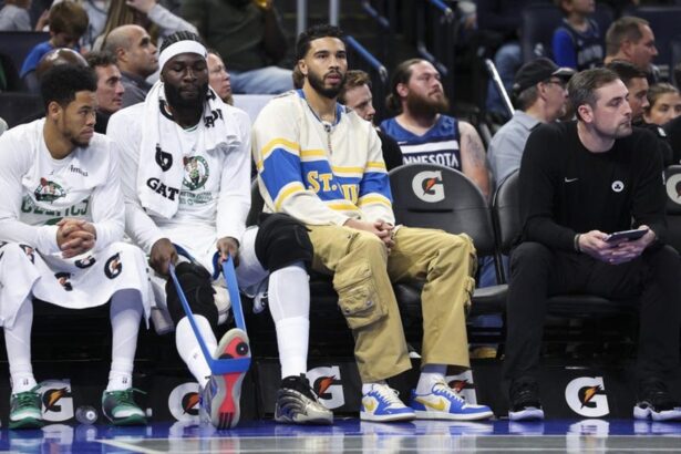 Nov 7, 2025; Orlando, Florida, USA; Boston Celtics forward Jayson Tatum (0) (center) looks on during a game against the Orlando Magic in the first quarter at Kia Center. Mandatory Credit: Nathan Ray Seebeck-Imagn Images