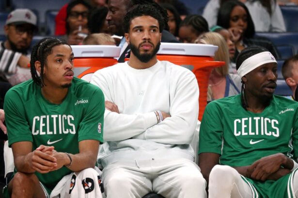 Oct 8, 2025; Memphis, Tennessee, USA; Boston Celtics forward Jayson Tatum (0) looks on from the bench during the second quarter against the Memphis Grizzlies at FedExForum. Mandatory Credit: Petre Thomas-Imagn Images