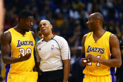 NBA referee Karl Lane talks with Los Angeles Lakers forward Julius Randle (30) and guard Kobe Bryant against the Phoenix Suns at Talking Stick Resort Arena. The Suns defeated the Lakers 119-107.