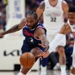 Apr 29, 2025; Denver, Colorado, USA; LA Clippers forward Kawhi Leonard (2) and Denver Nuggets guard Russell Westbrook (4) reach for a loose ball in the second half during game five of the first round for the 2025 NBA Playoffs at Ball Arena. Mandatory Credit: Ron Chenoy-Imagn Images