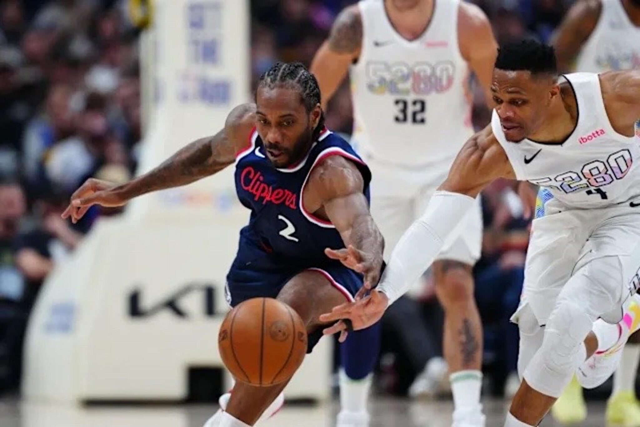 Apr 29, 2025; Denver, Colorado, USA; LA Clippers forward Kawhi Leonard (2) and Denver Nuggets guard Russell Westbrook (4) reach for a loose ball in the second half during game five of the first round for the 2025 NBA Playoffs at Ball Arena. Mandatory Credit: Ron Chenoy-Imagn Images