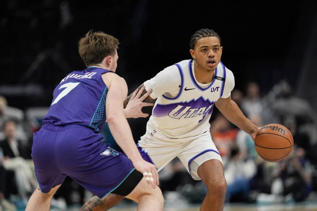 Utah Jazz guard Keyonte George (3) handles the ball against Charlotte Hornets guard Kon Knueppel (7) during the second half at Spectrum Center.
