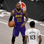 Apr 9, 2025; Dallas, Texas, USA; Los Angeles Lakers forward LeBron James (23) and Dallas Mavericks forward Naji Marshall (13) in action during the game between the Dallas Mavericks and the Los Angeles Lakers at American Airlines Center. Mandatory Credit: Jerome Miron-Imagn Images